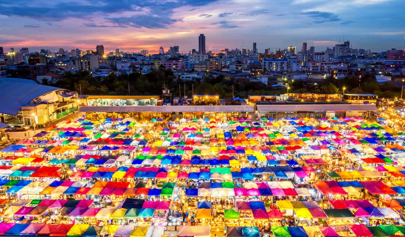 The massive and colorful weekend market in Bangkok, Thailand lit up at night