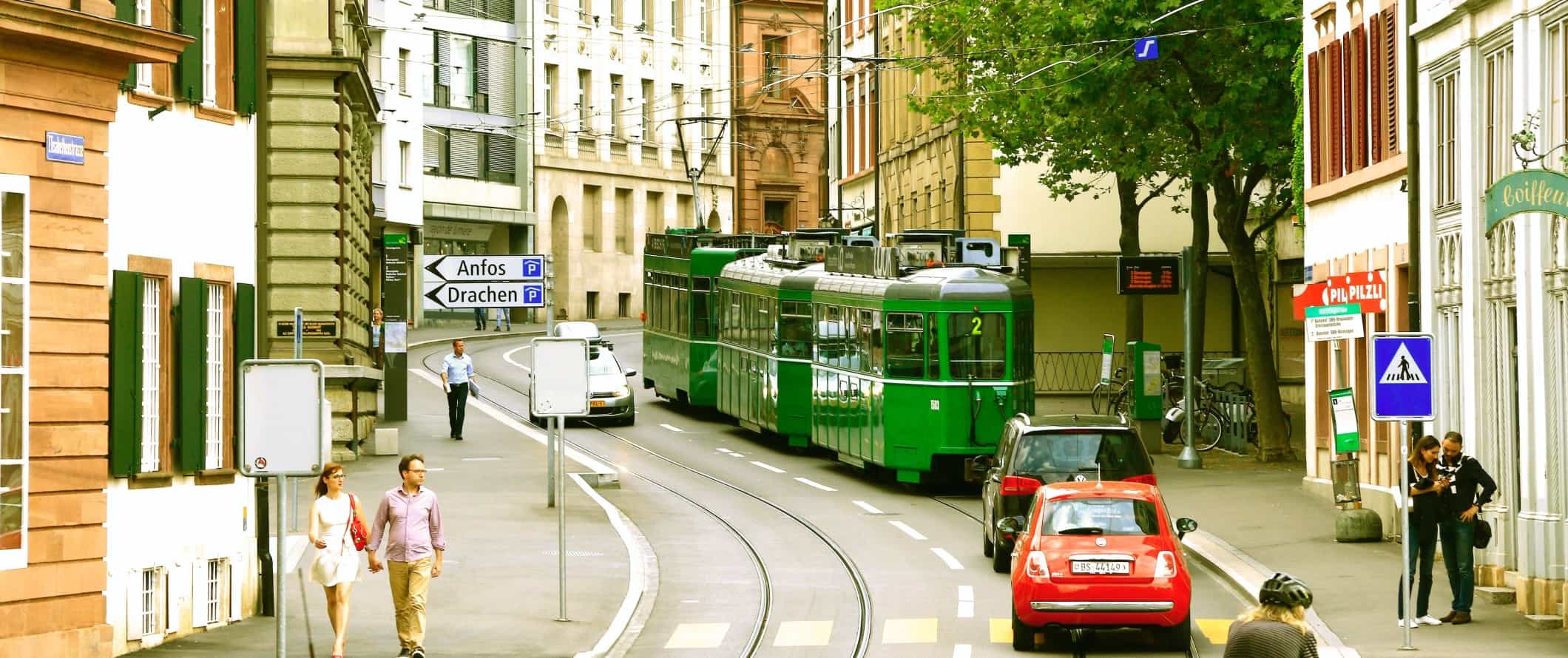 Curved street with a tram going down it in Basel, Switzerland
