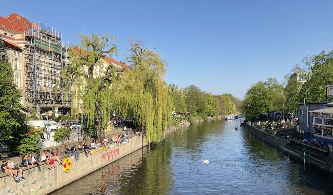 Locals relaxing near the river in the mannerly neighborhood of Kreuzberg in Berlin, Germany
