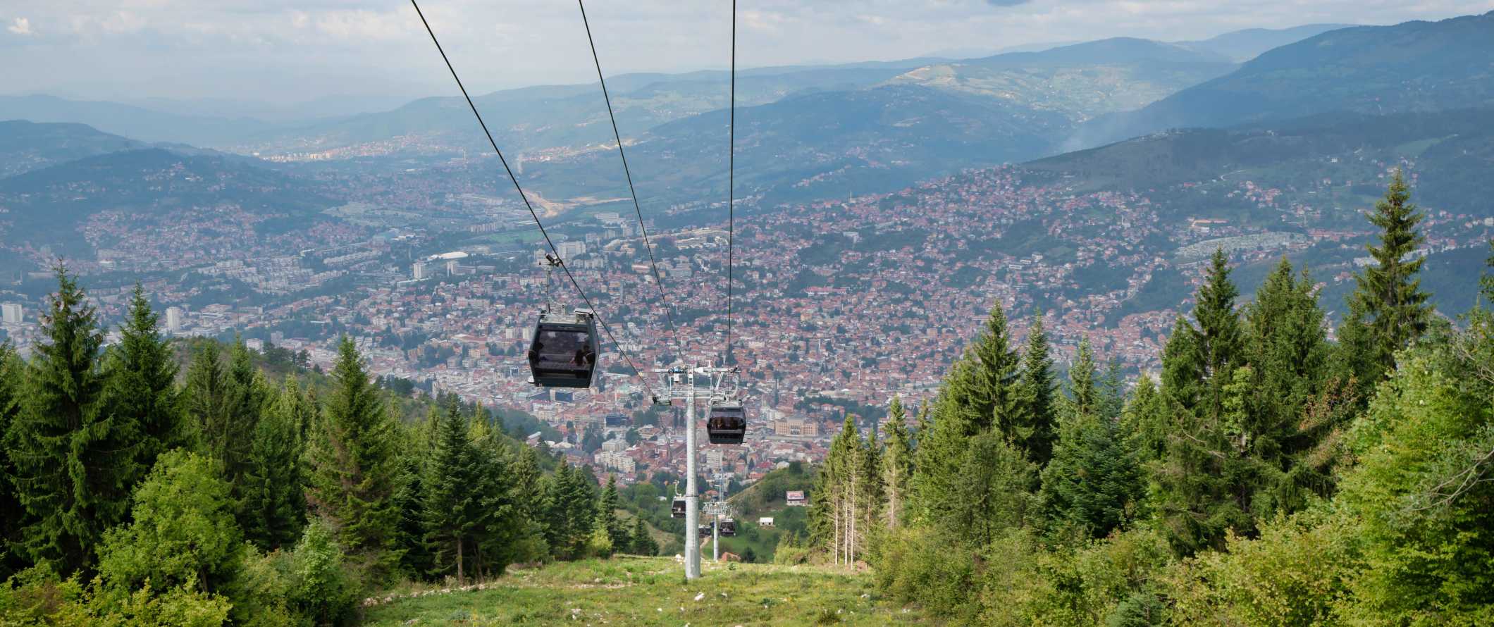 Cable cars descending from a mountain into the city of Sarajevo, in Bosnia & Herzegovina