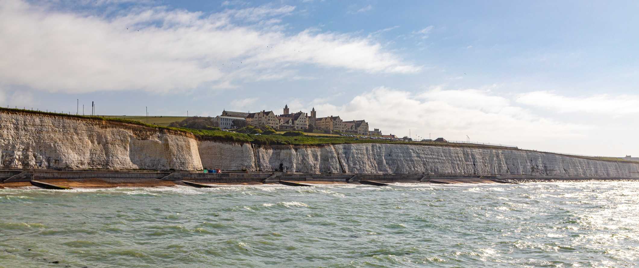 White cliffs rising up out of the ocean in Brighton, UK