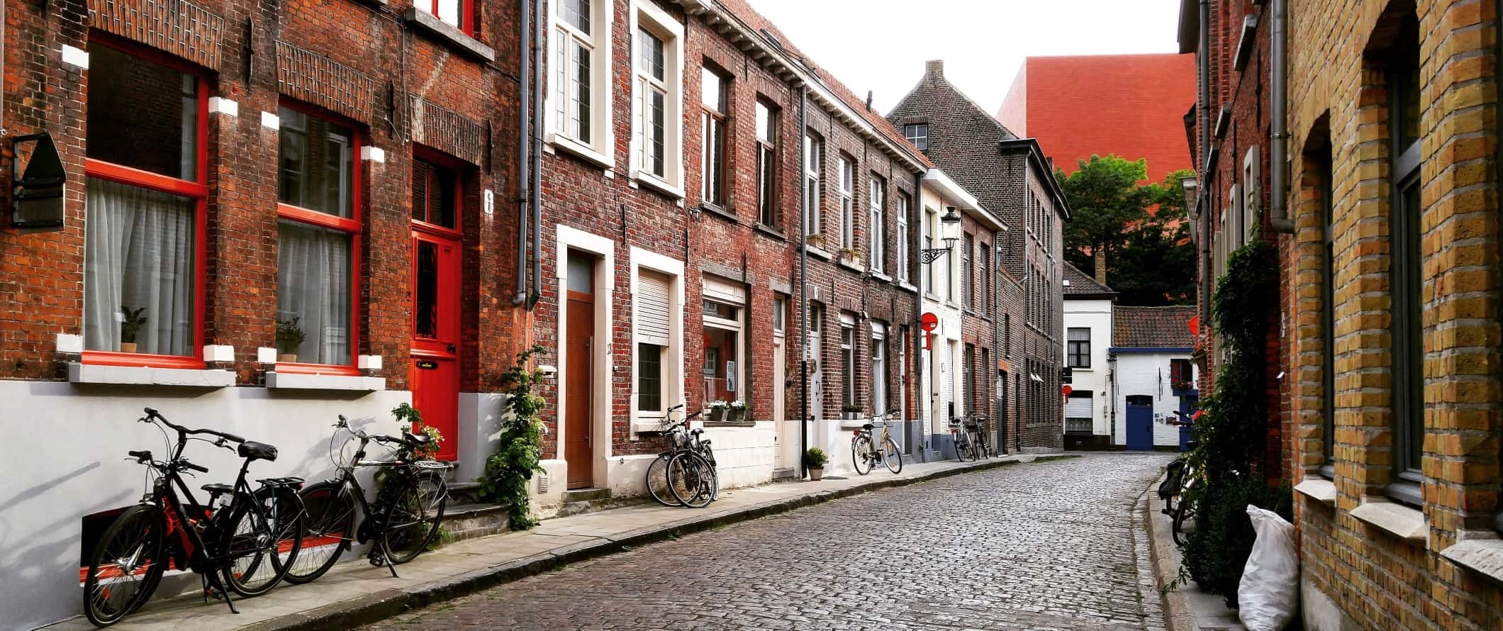 Cobblestone-street with bicycles parked along the side of the road in Bruges, Belgium.