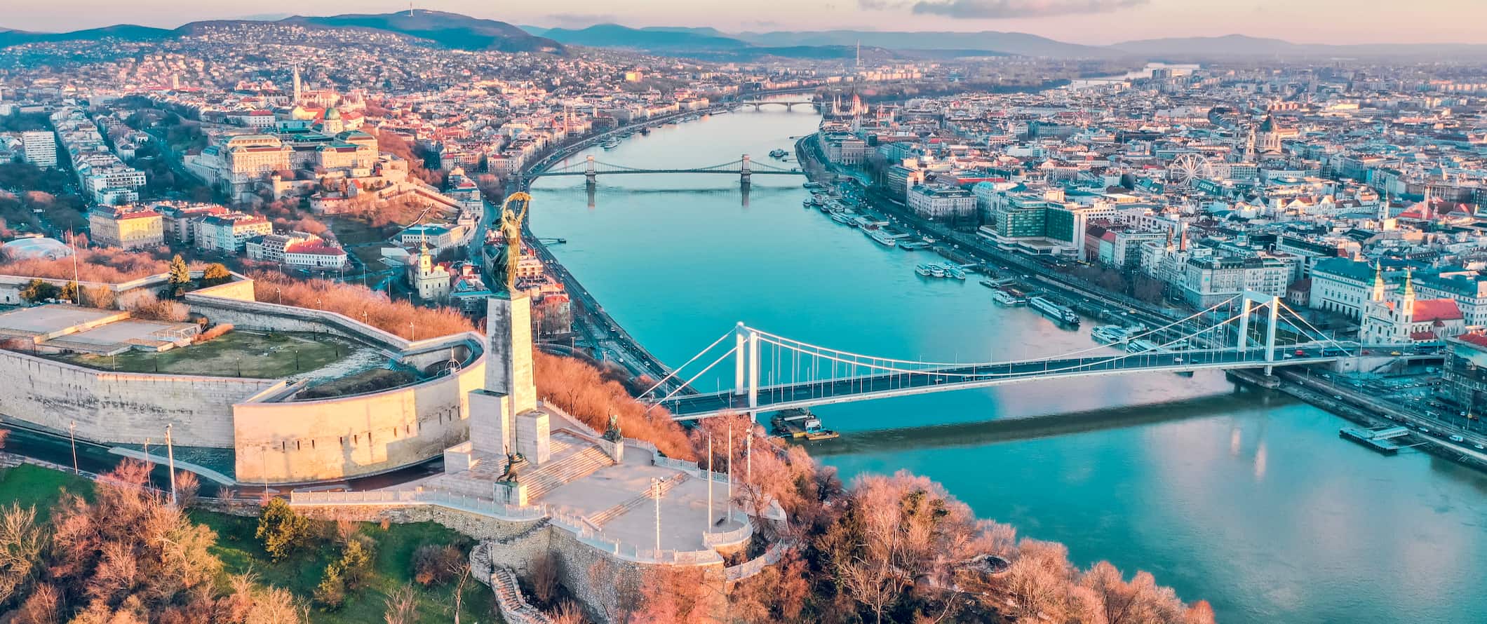 A view overlooking Budapest, Hungary from above, featuring historic buildings and the beautiful Danube
