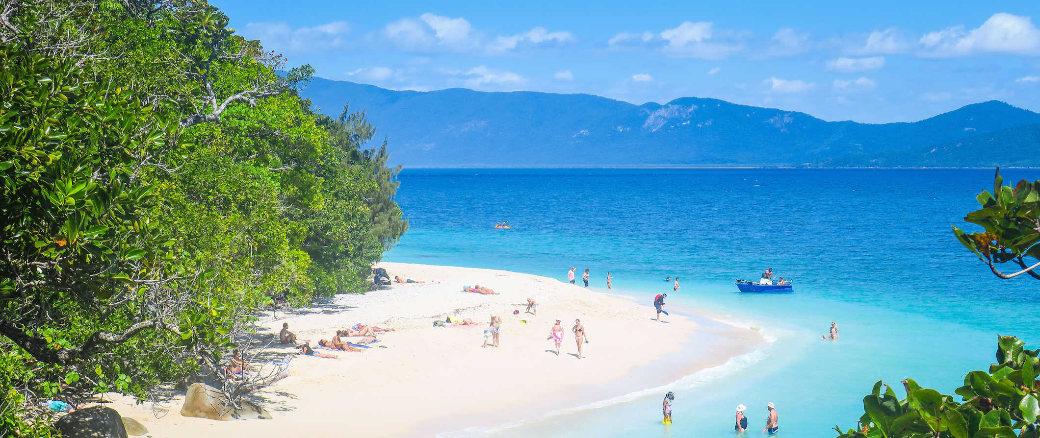 People having fun in the sun on the beach on an island near Cairns, Australia