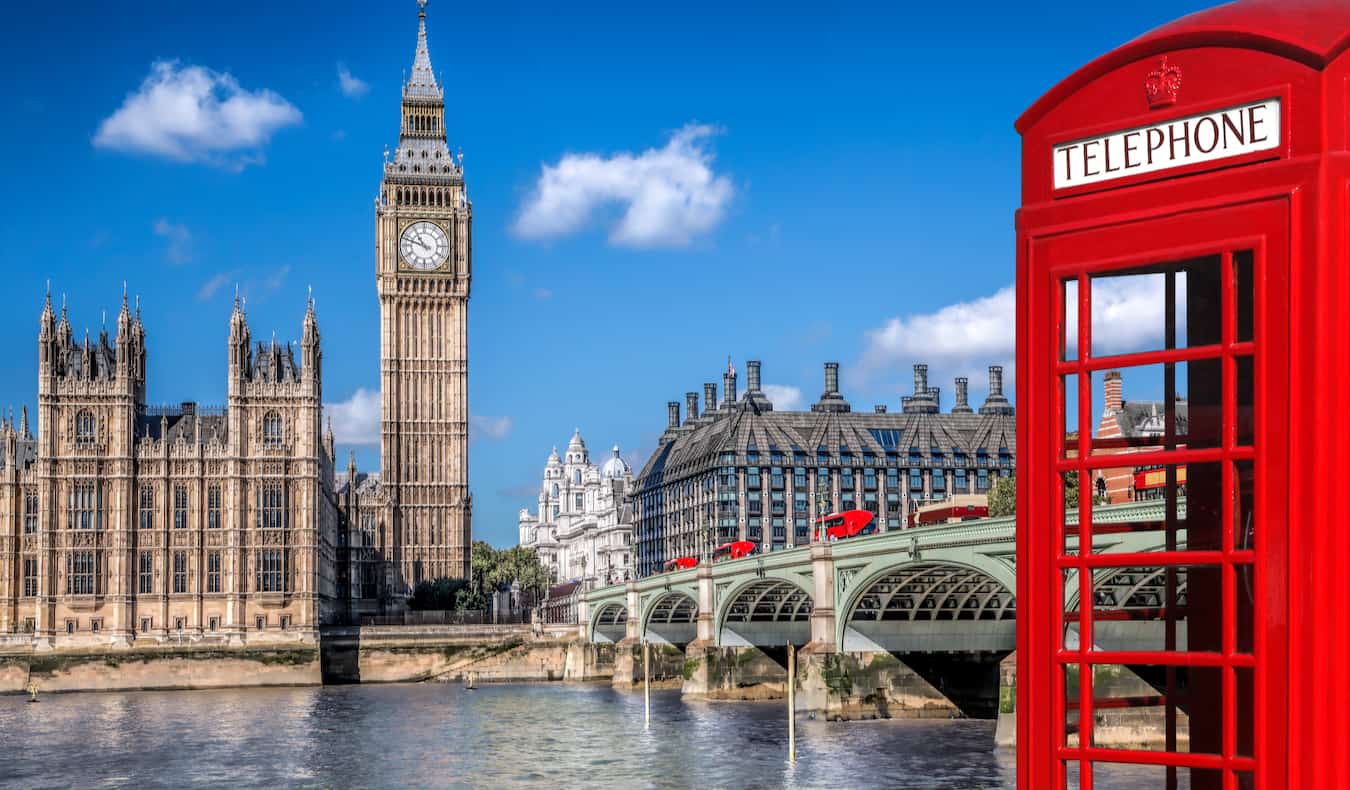 Buckingham Palace and a classic red telephone booth in London, England