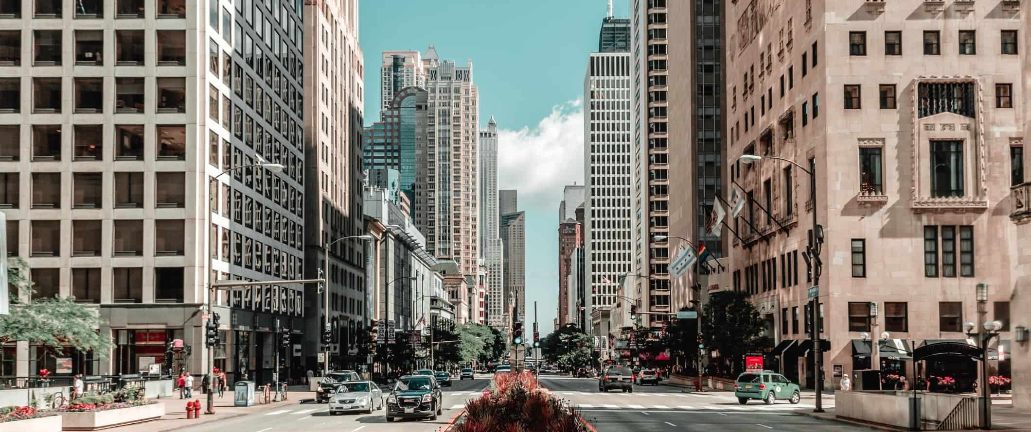 Large avenue with median in the middle and tall buildings in Chicago, USA.