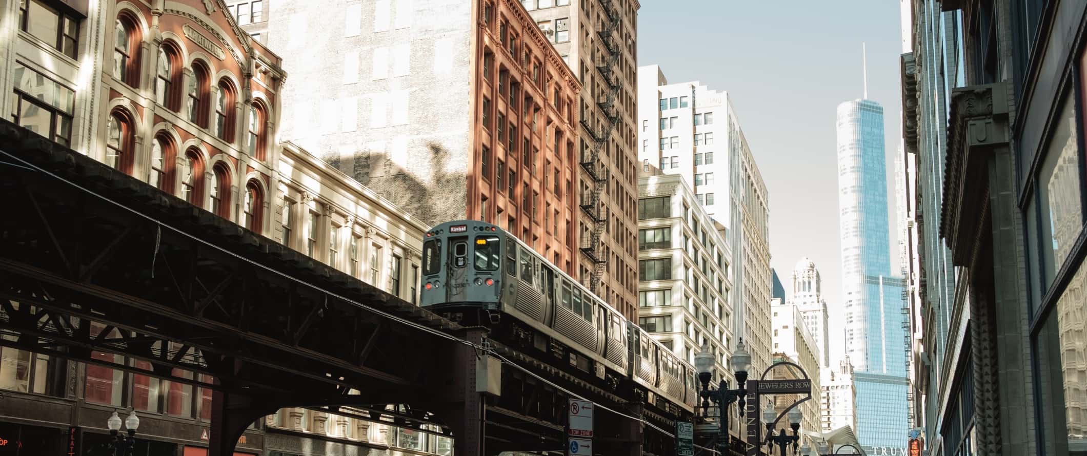 Elevated train going through tall buildings in Chicago, USA.