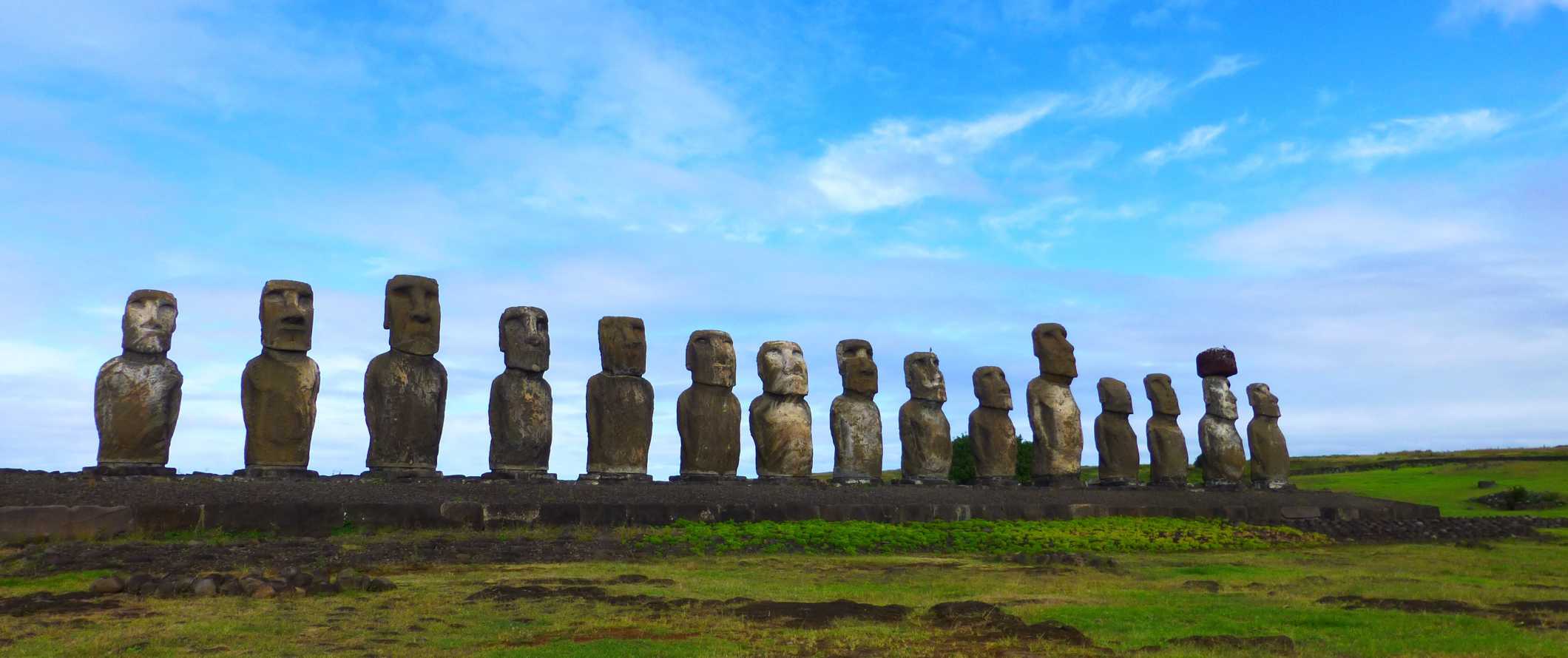 Giant stone heads lined up next to each other on Easter Island off the coast of Chile
