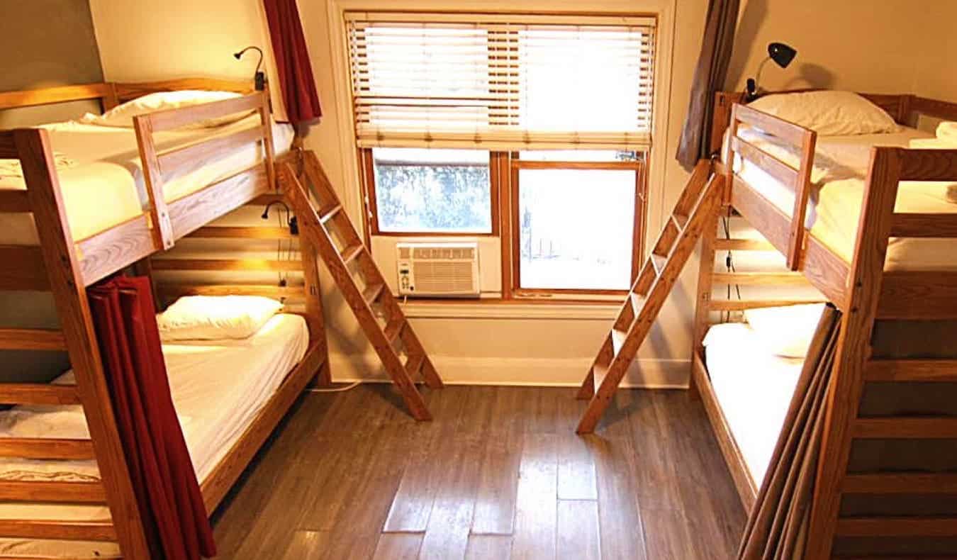 Dormitory room with two wooden bunk beds located at The Clarence Park in Toronto, Canada