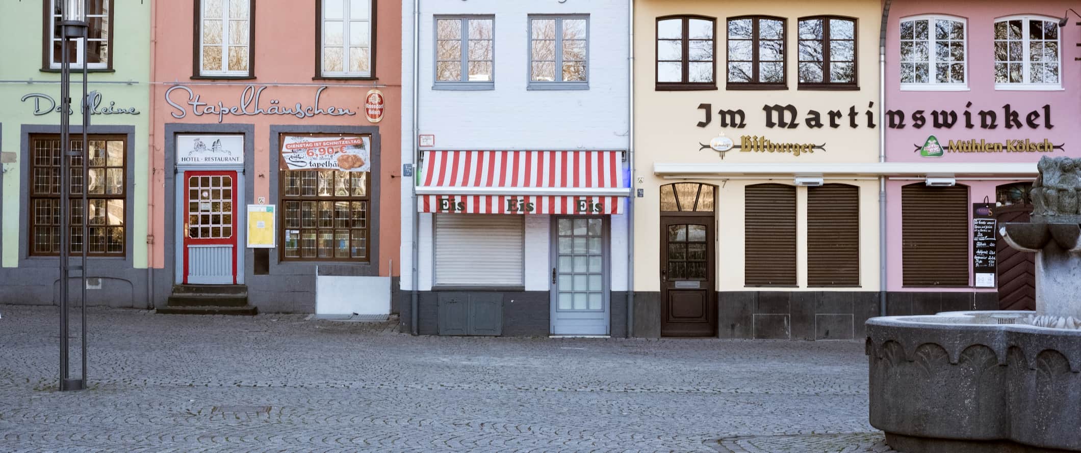 A row of old buildings lining a street in Cologne, Germany