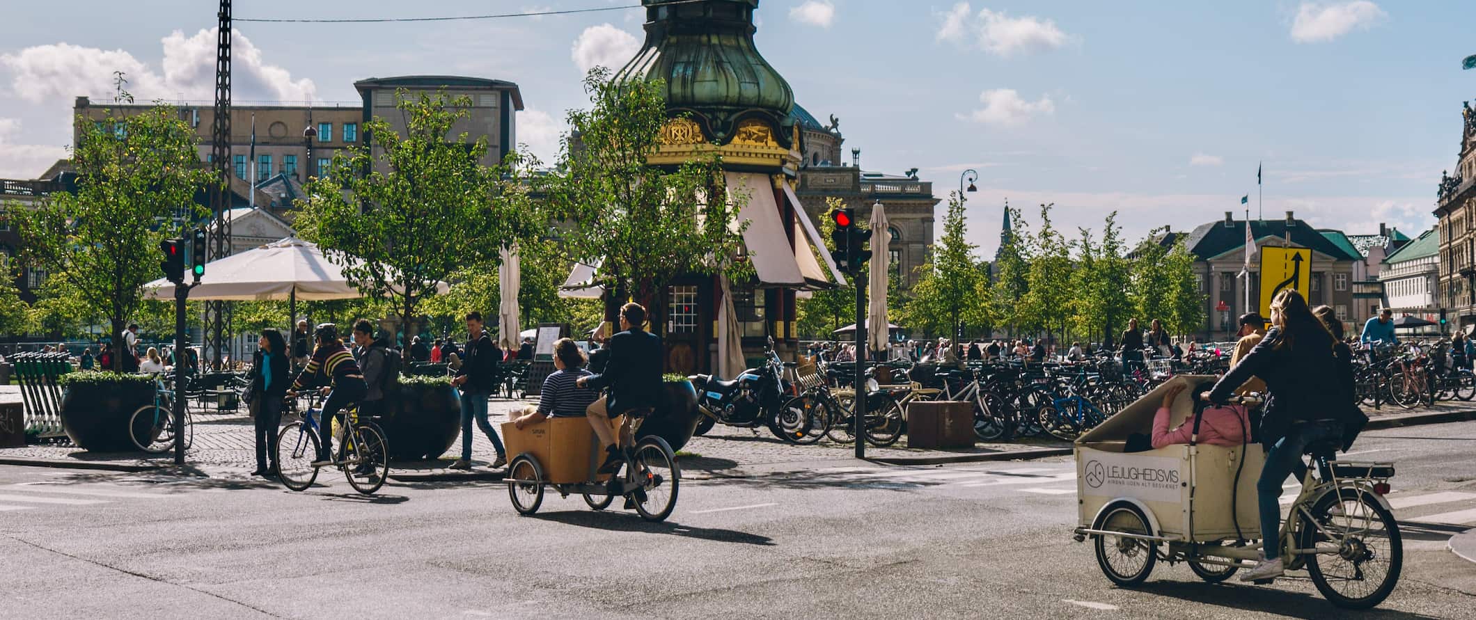 People cycling on a sunny summer day in Copenhagen, Denmark