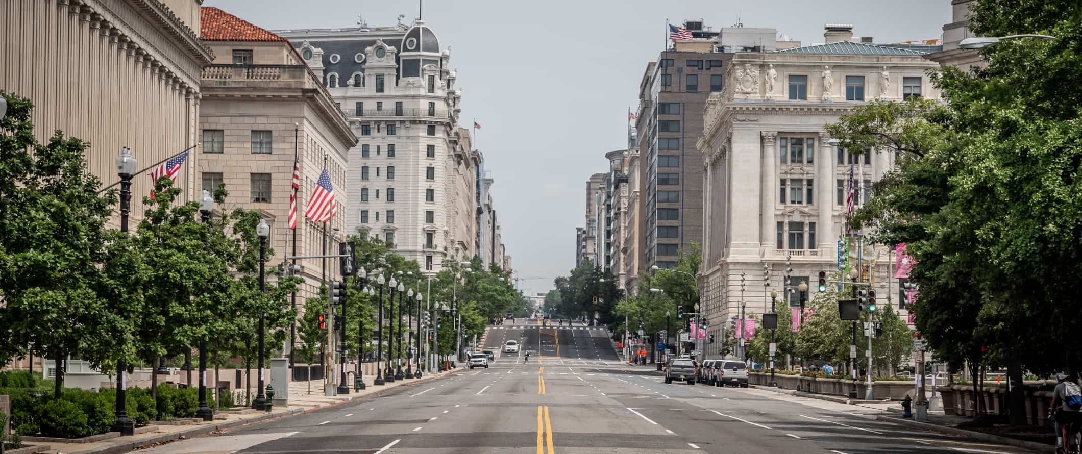 Wide street with stately government buildings in Washington, DC.