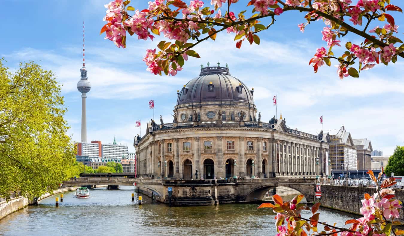 Historic buildings along the water in Berlin, Germany with the Berlin TV tower in the background