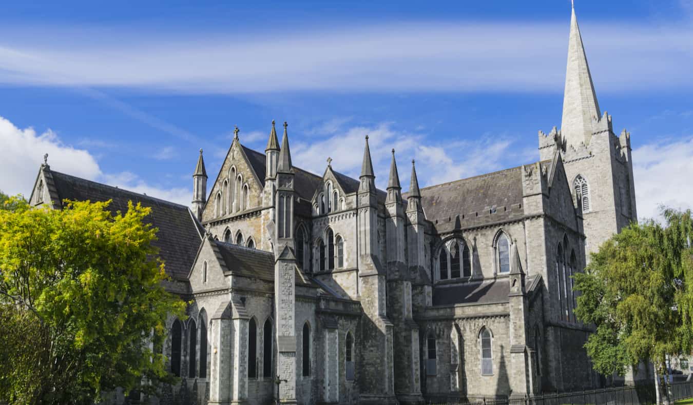 The towering St. Patrick's Cathedral in Dublin, Ireland set against a bright blue sky