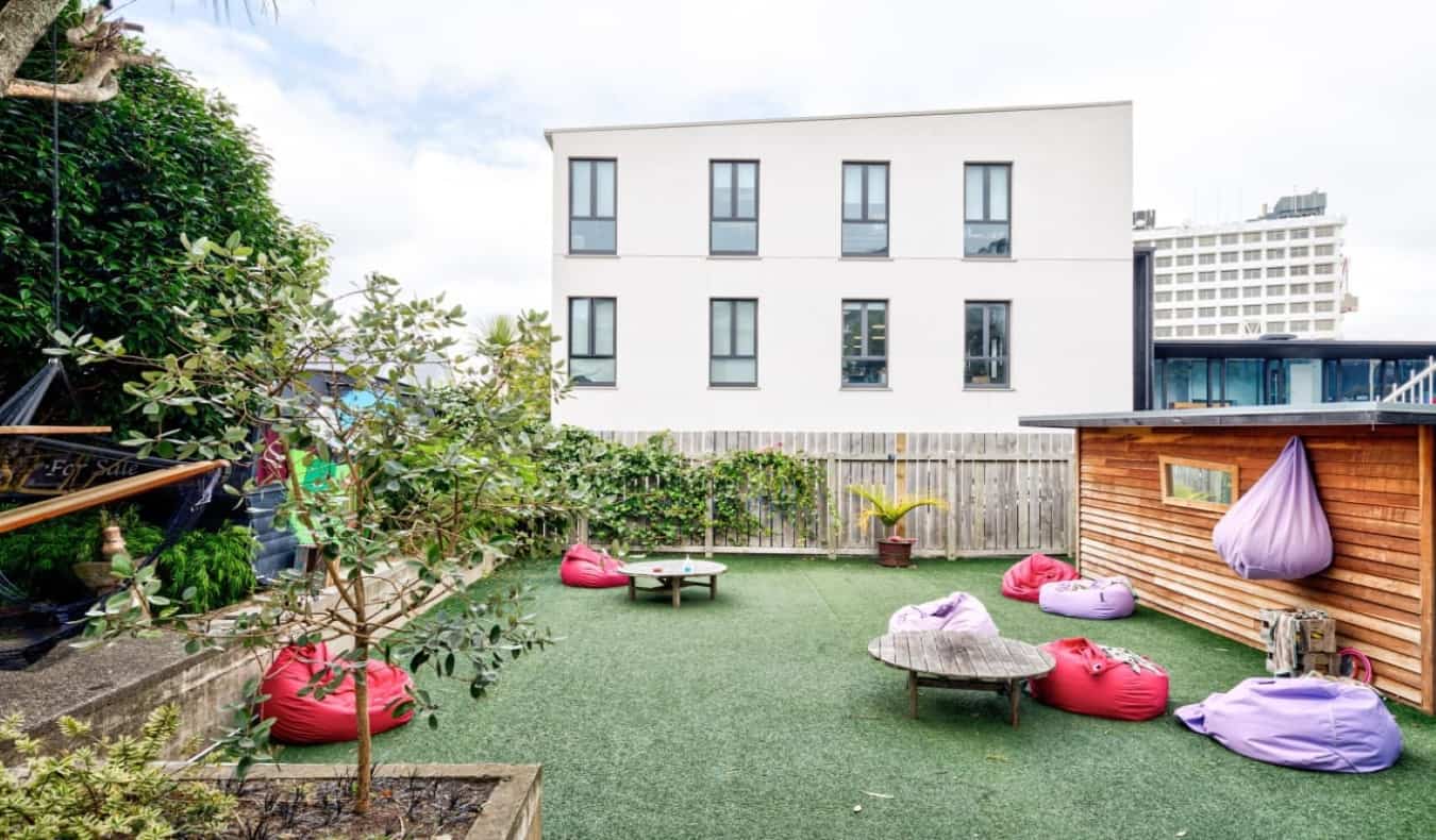 outdoor backyard with bean bag chairs at The Dwellington hostel in Wellington, New Zealand.