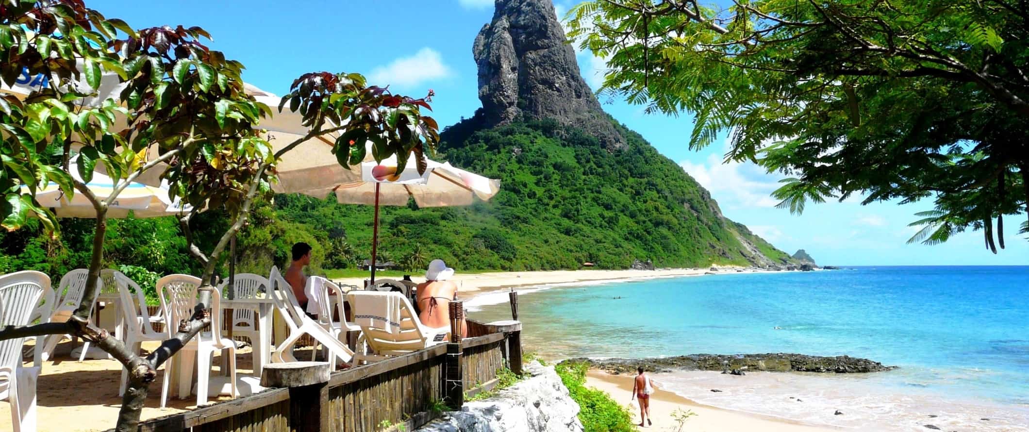 People sitting at a beachside cafe in Fernando de Noronha, Brazil