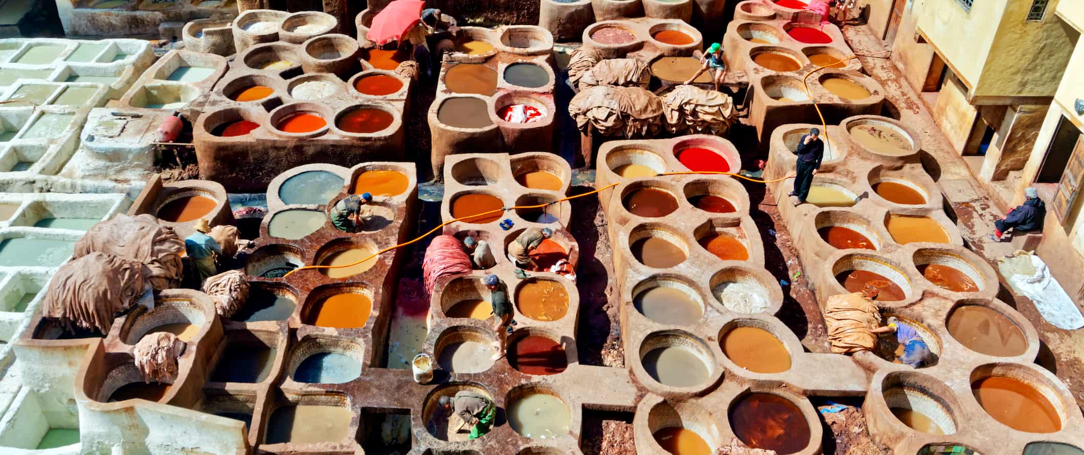 The huge, historical tannery in Fez surrounded by old, traditional Moroccan houses and buildings