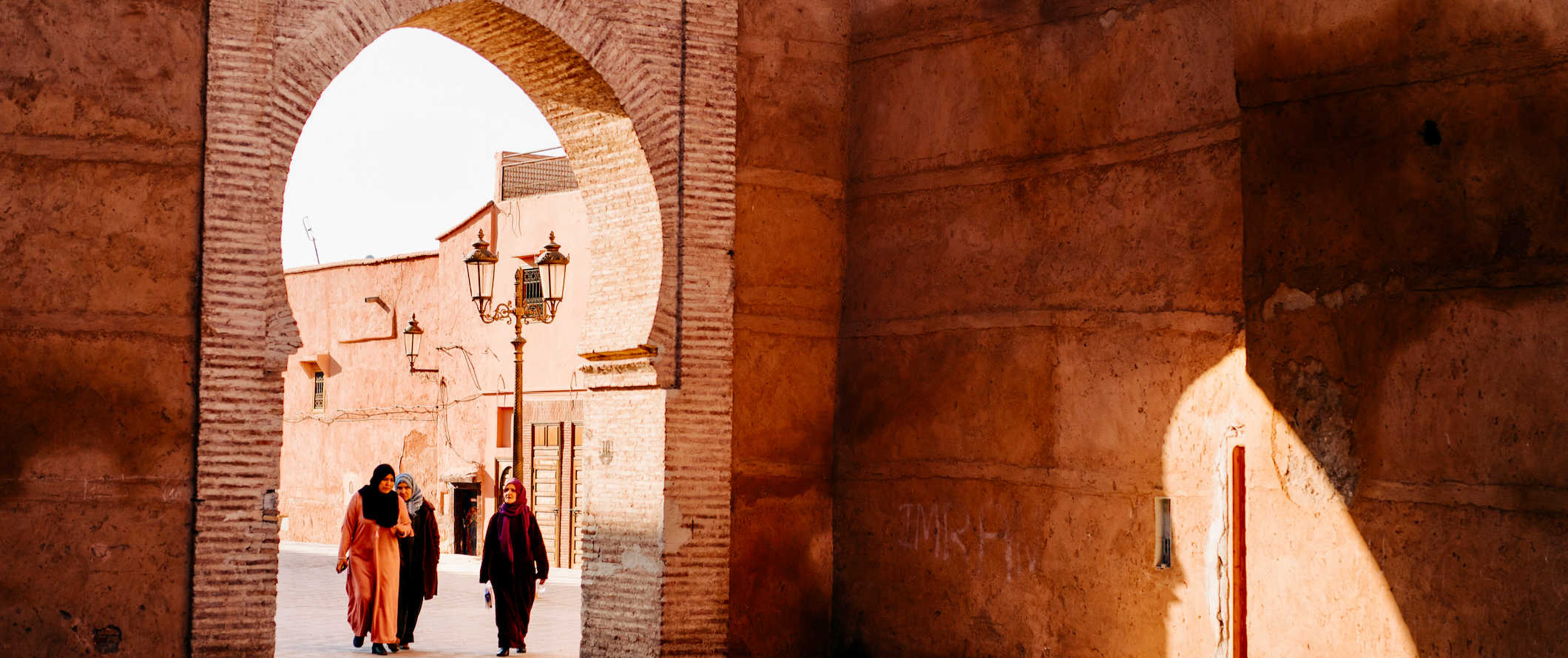 Women in scarves walking around the medina in Fez, Morocco