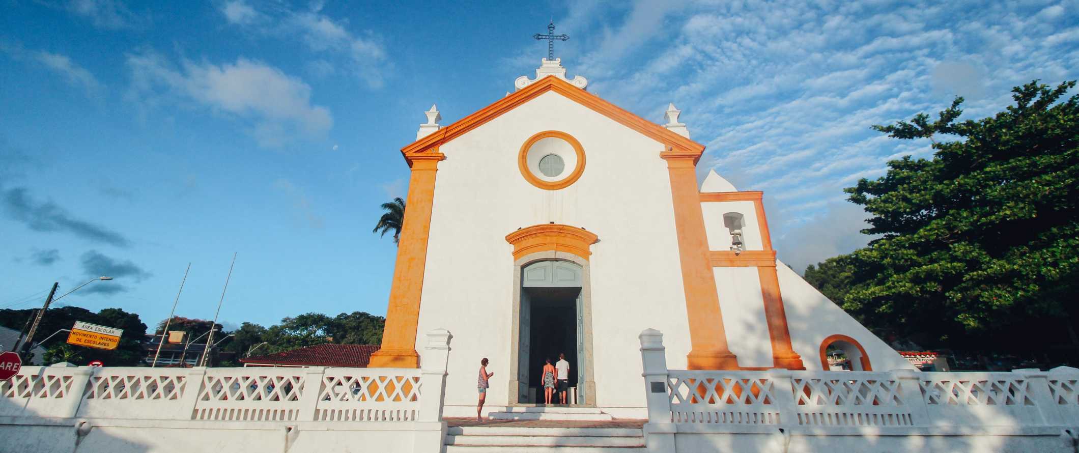 White-washed colonial church with bright orange trim in Florianopolis, Brazil