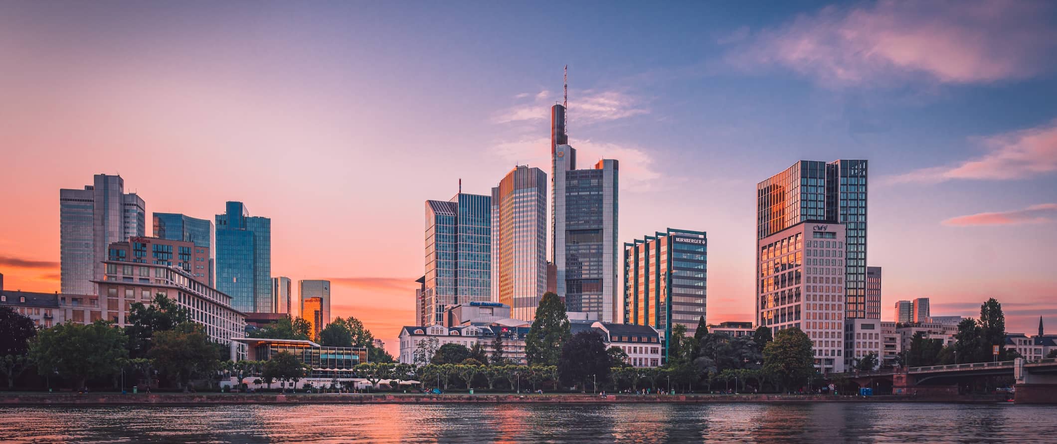 the towering skyline of Frankfurt, Germany during a colorful sunset