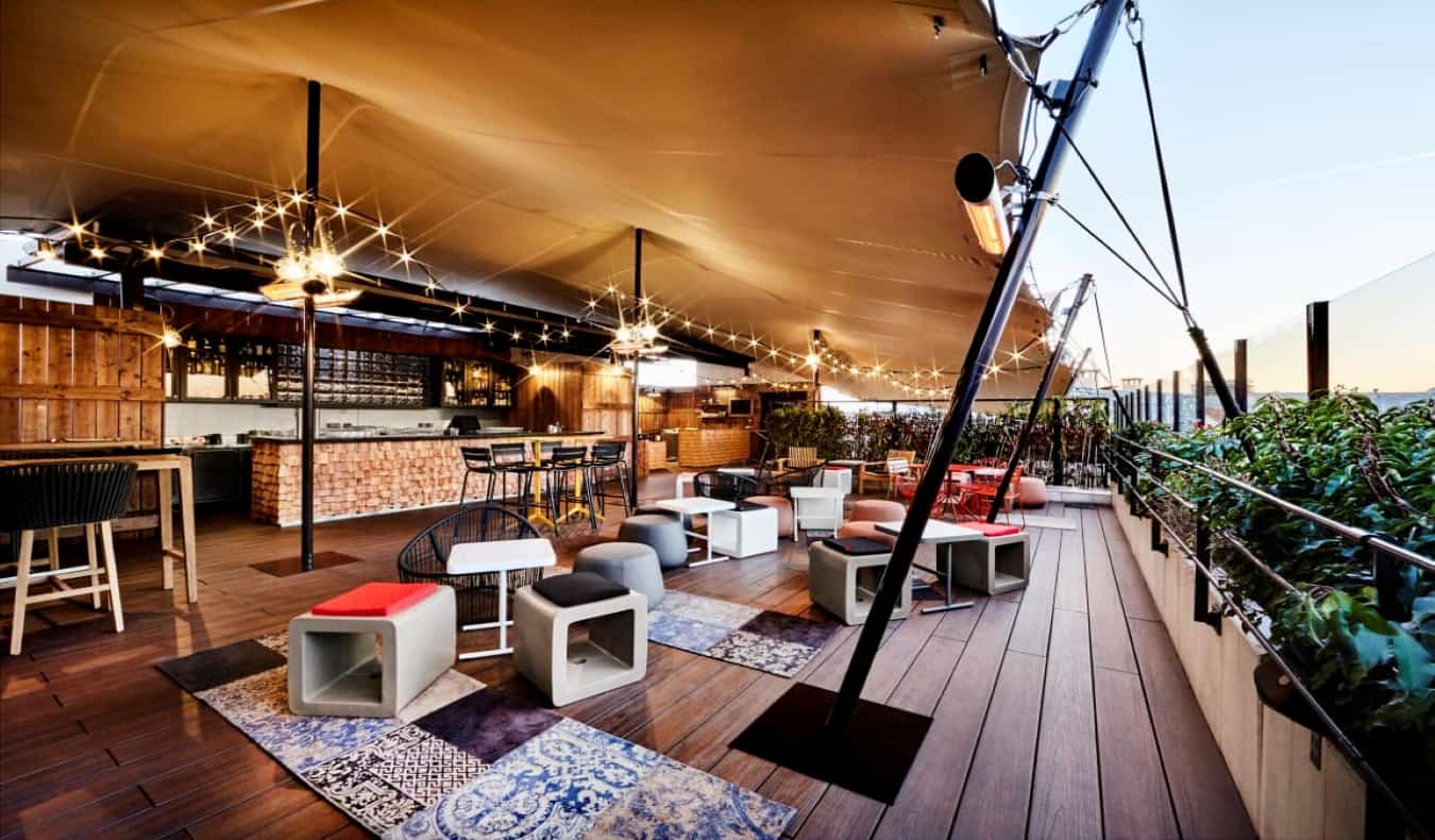 large covered rooftop terrace with lots of seating at Generator Hostel, Paris
