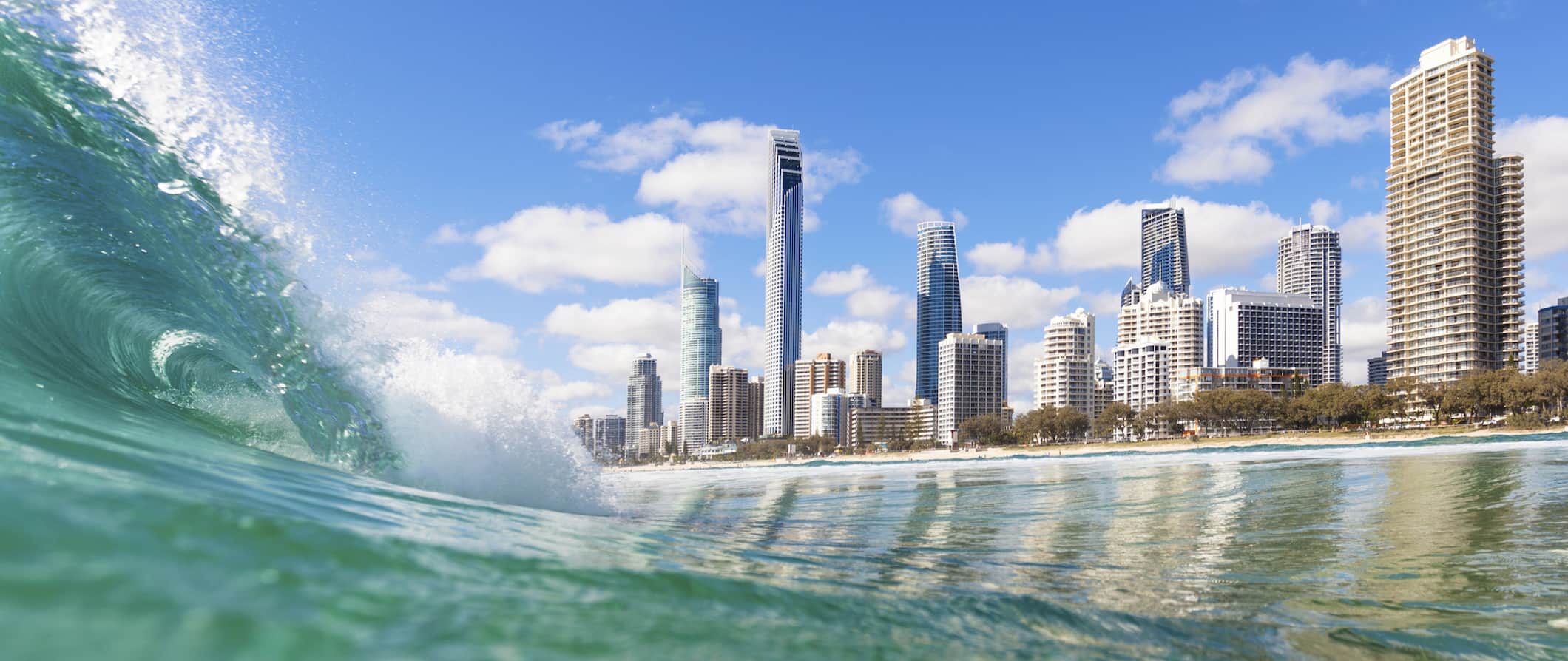 Clear water of a huge wave as someone surfs along the stunning coast of Gold Coast, Australia