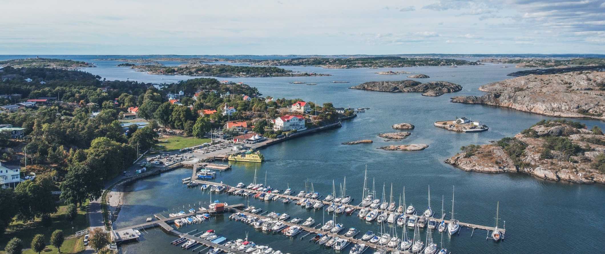 Aerial view of a harbor filled with sailboats and islands in the background in Gothenburg, Sweden