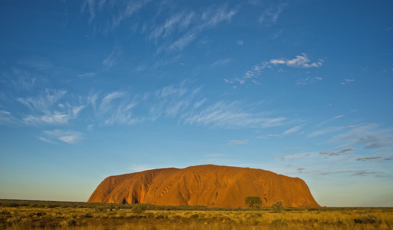The iconic Uluru in Australia surrounded by a bright blue sky
