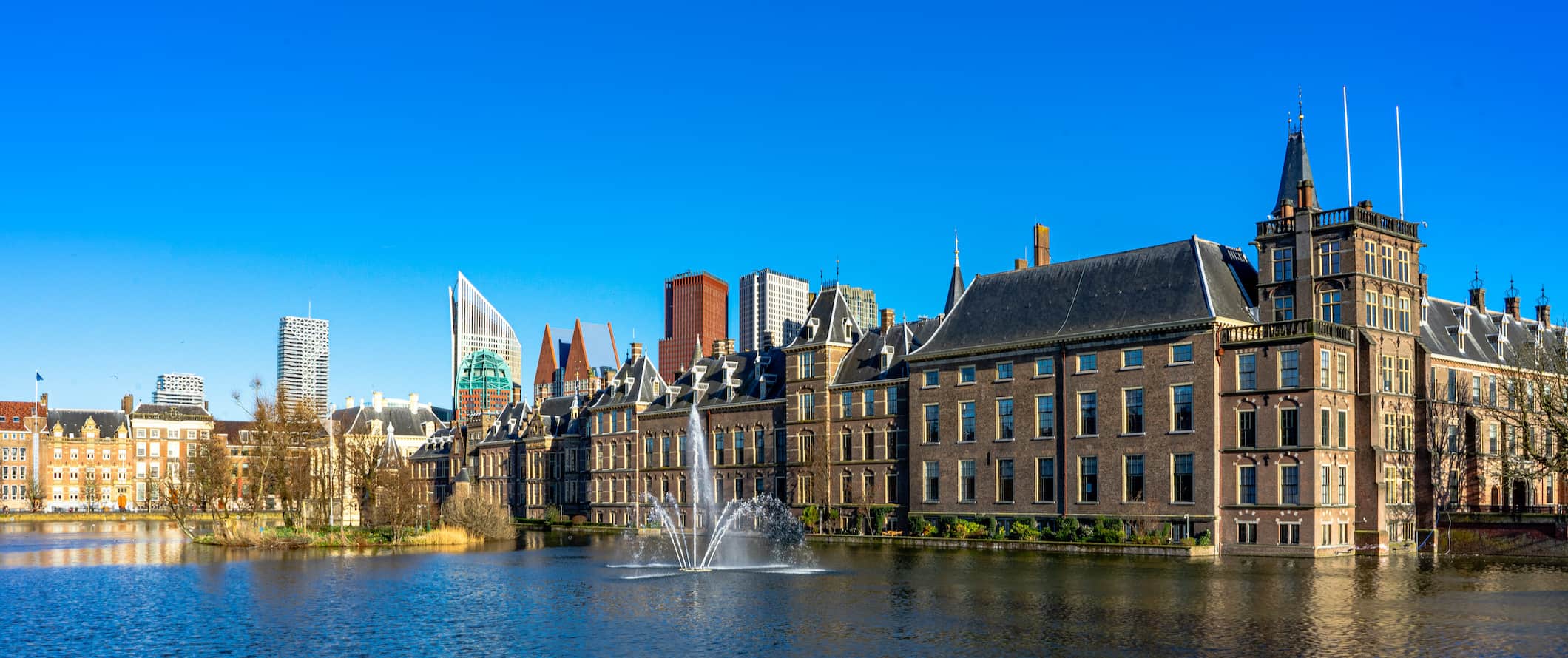 A view of The Hague, in The Netherlands near the water, featuring old buildings on a sunny summer day