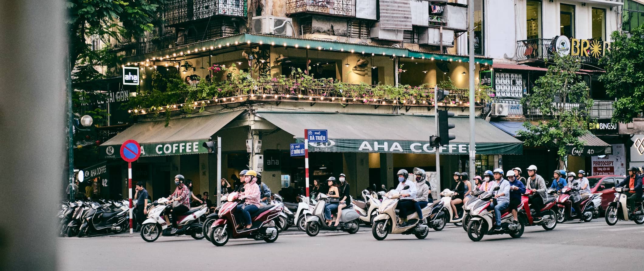 sunset and people on bikes in Hanoi