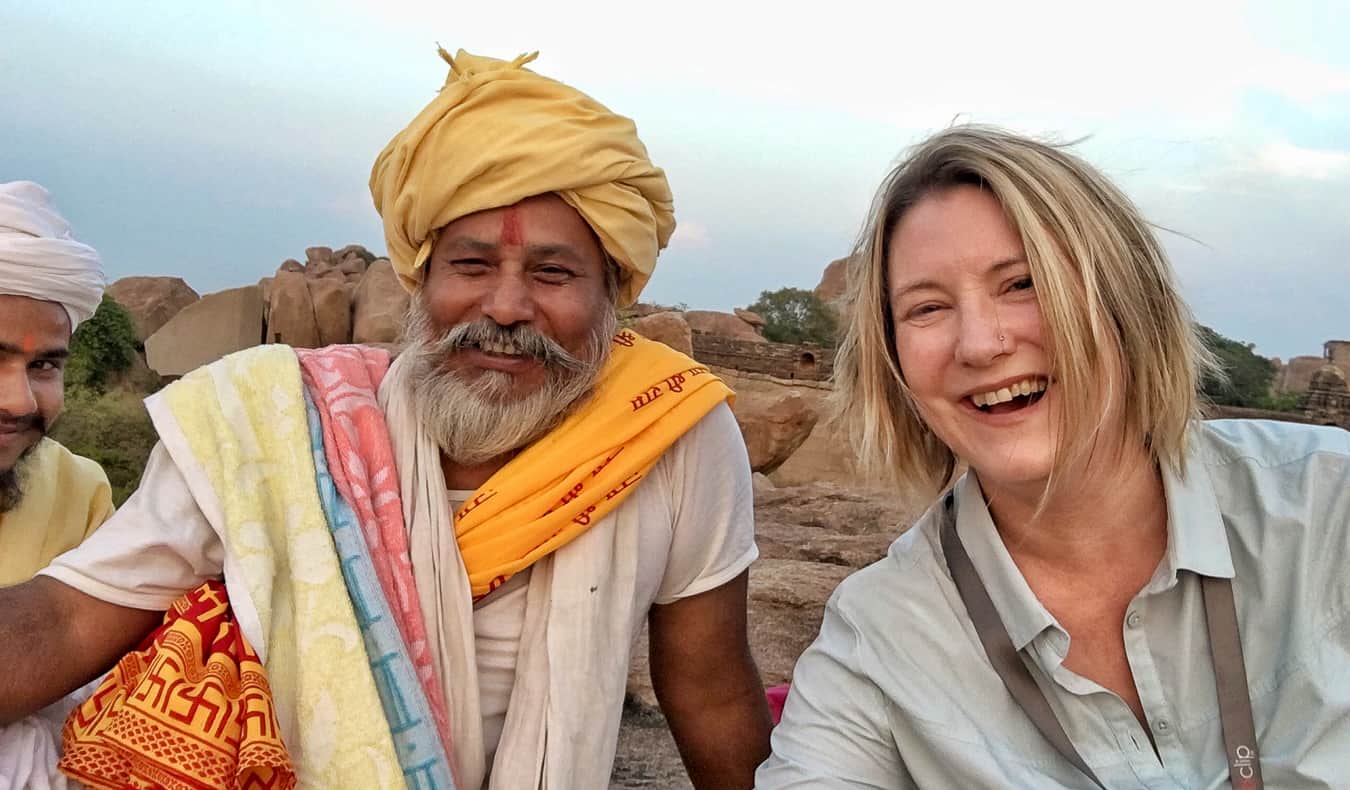 A solo female traveler in India posing with a local man