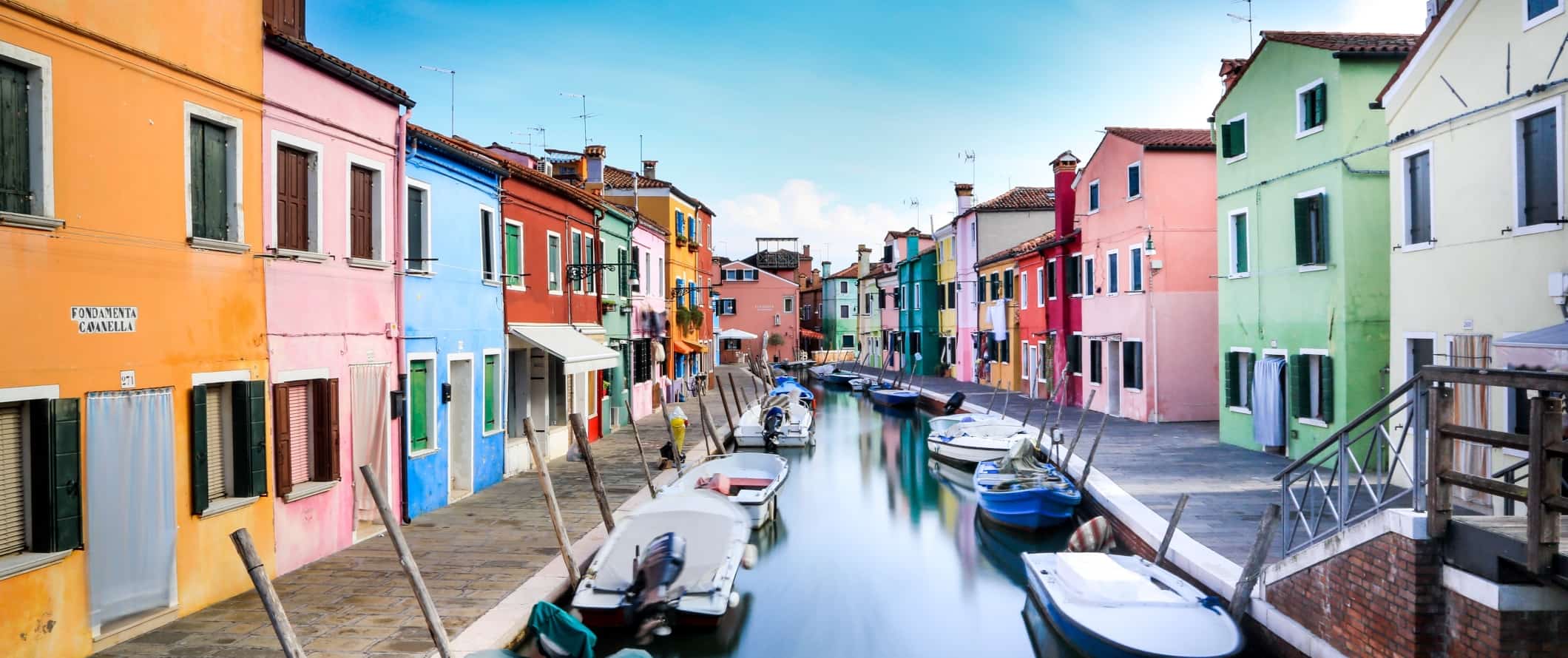 Colorful buildings along the canal in Burano, an island near Venice, Italy.