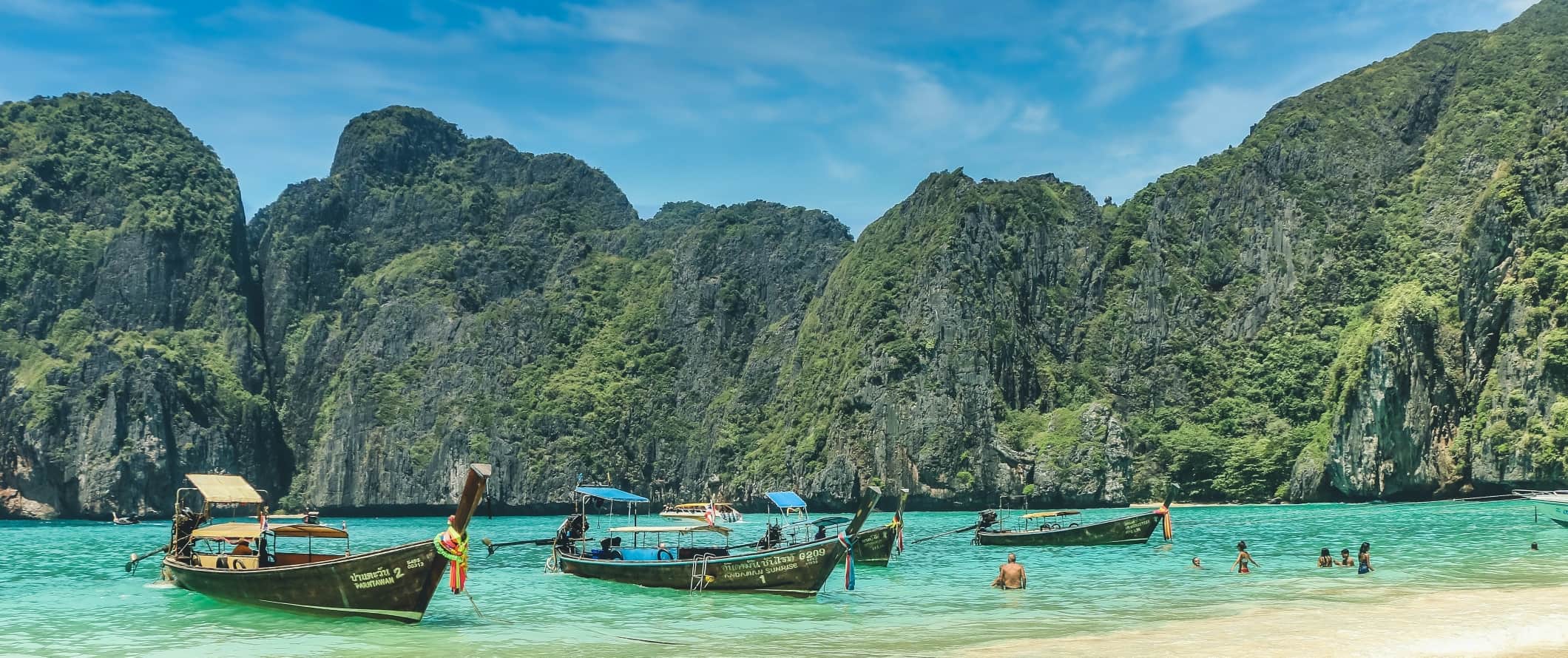 Longtail boats pulled up on the beach on the island of Ko Phi Phi, Thailand