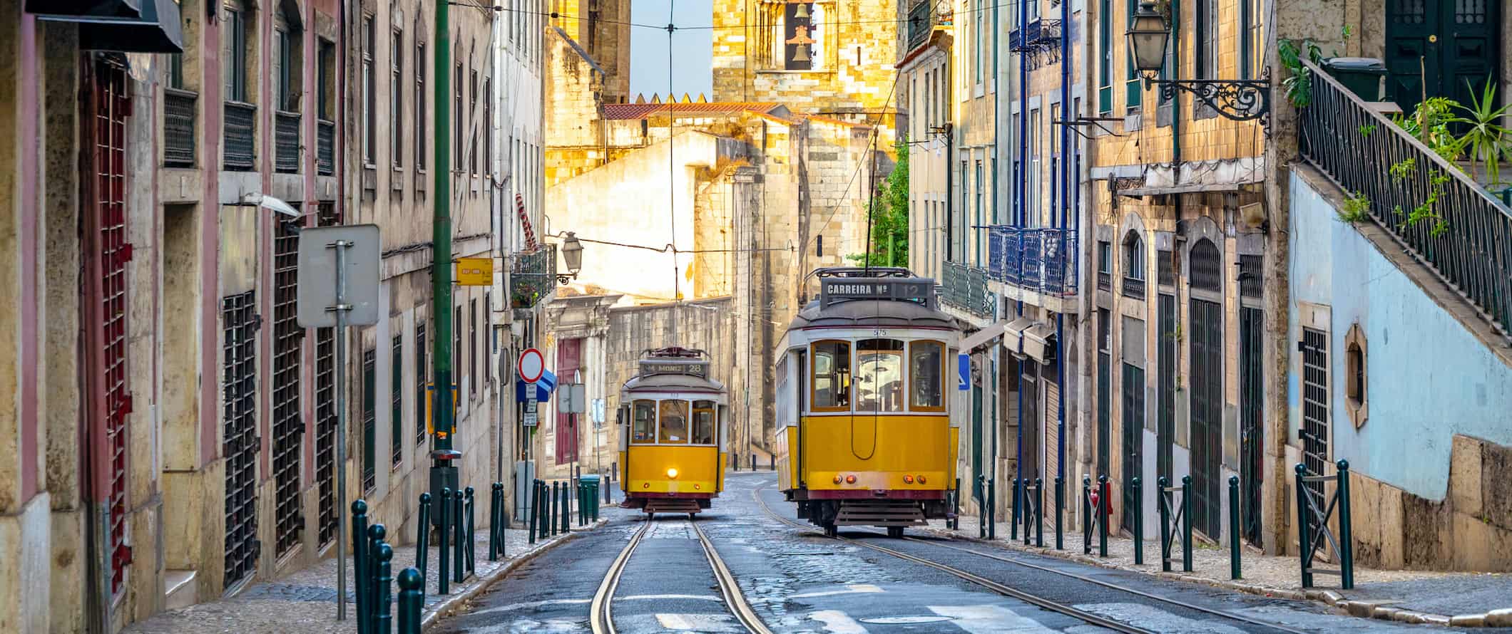 Old yellow street cars on a narrow street in the colorful city of Lisbon, Portugal