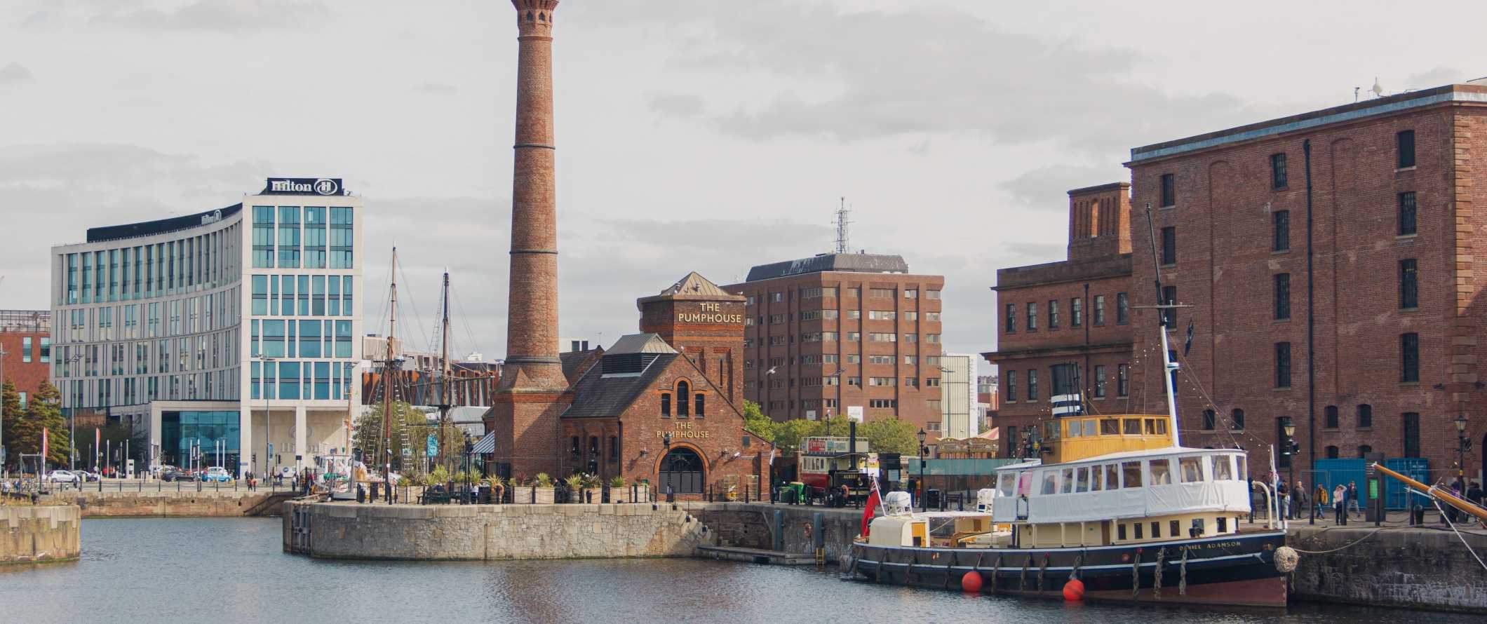 Historic boat, warehouses, and pumphouse at the Royal Albert Dock in Liverpool, England