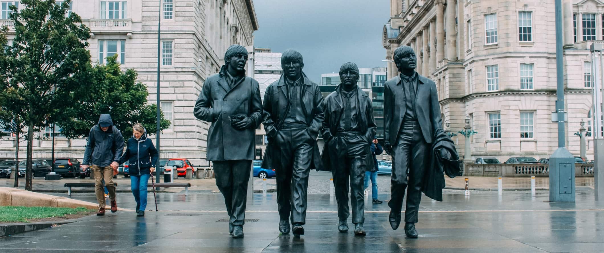 Life-size statue of the Beatles walking down the street in Liverpool, England