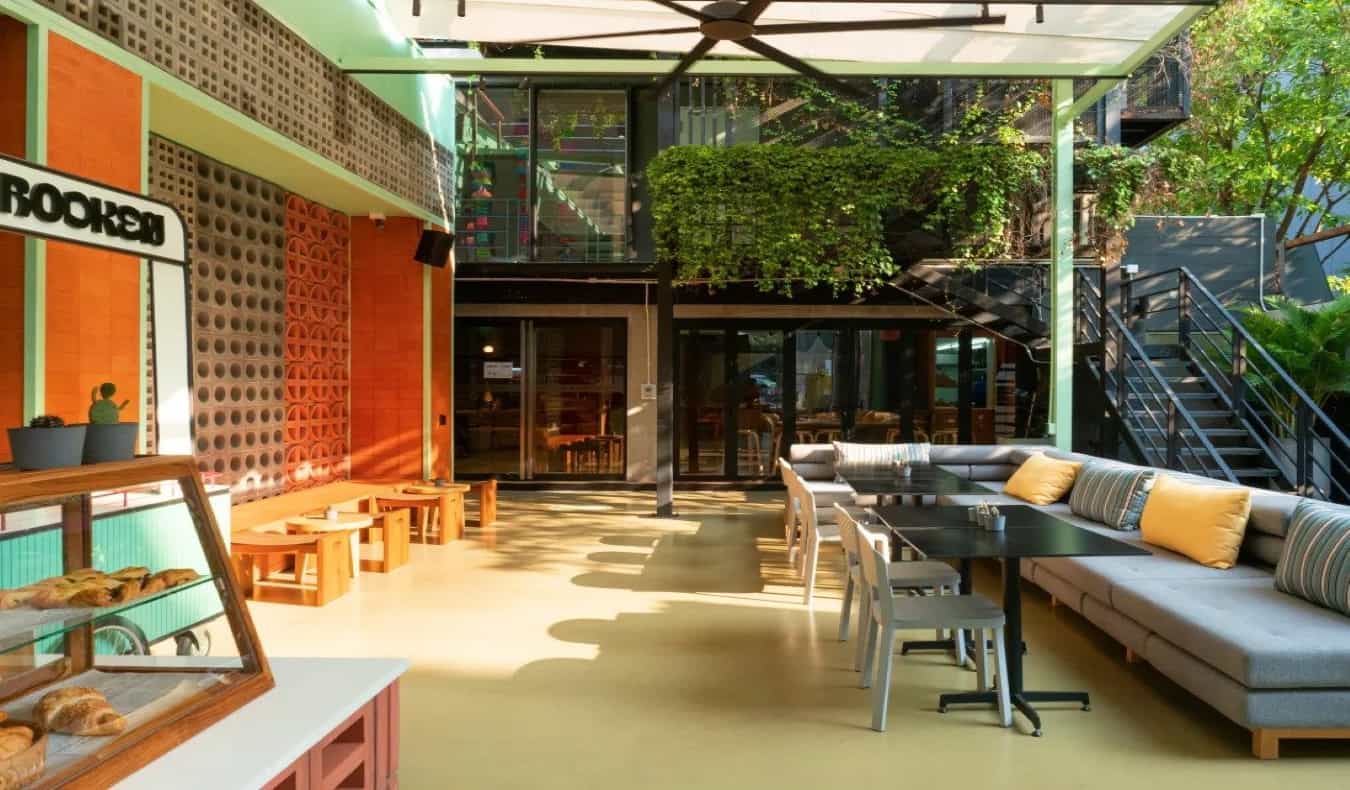 Spacious common area with tables and couches at Lub d Bangkok Siam, a hostel in Bangkok, Thailand.