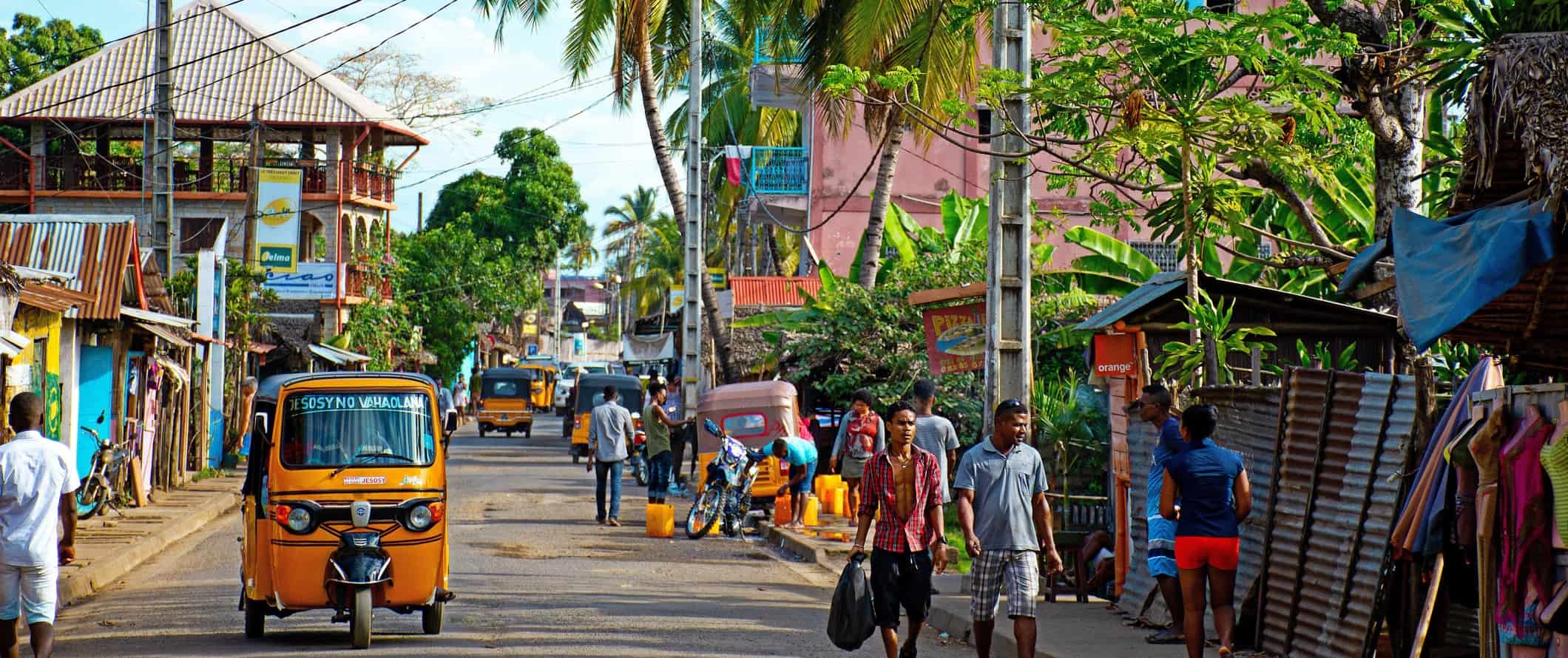 People walking down a busy street in a small town in Madagascar, Africa