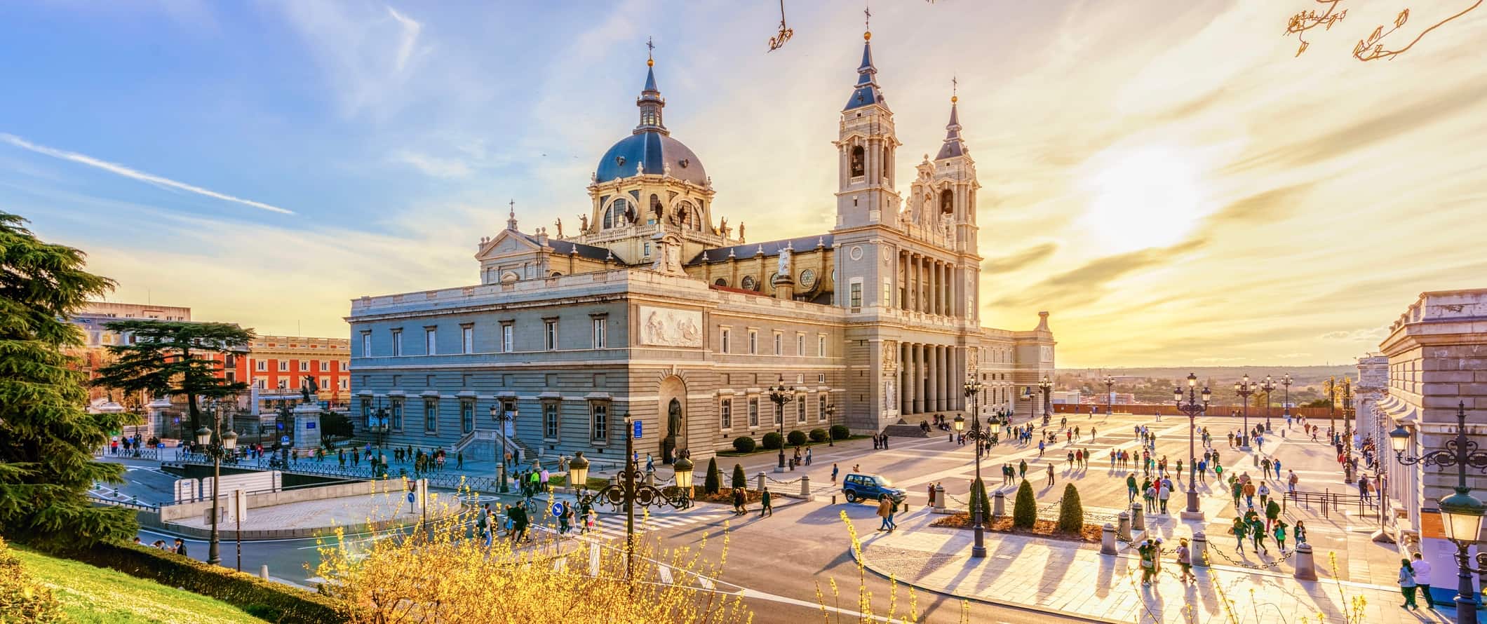 The stunning and historic architecture of Madrid, Spain near a large plaza during sunset