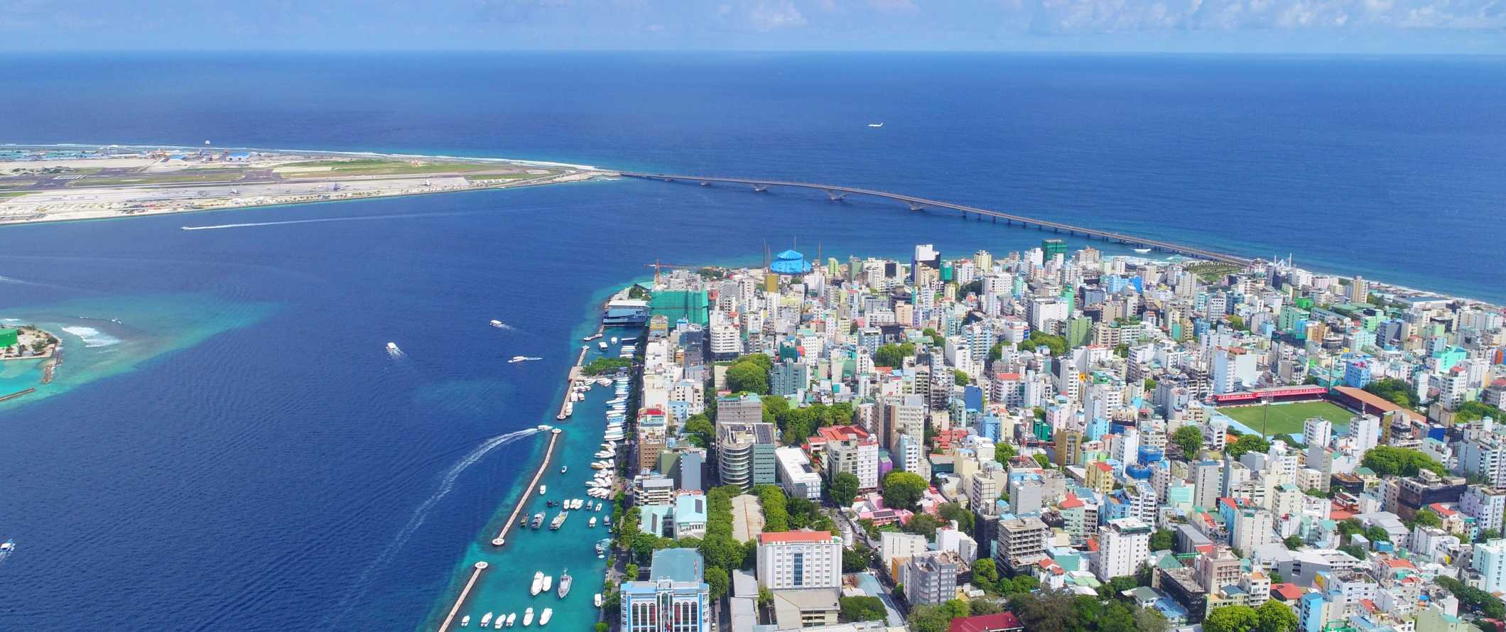Aerial view of the city of Male surrounded by the dark blue ocean in the Maldives