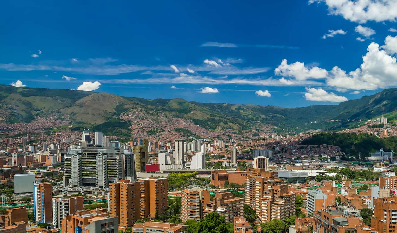 Skyline of Medellin, Colombia surrounded by greenery on a sunny day