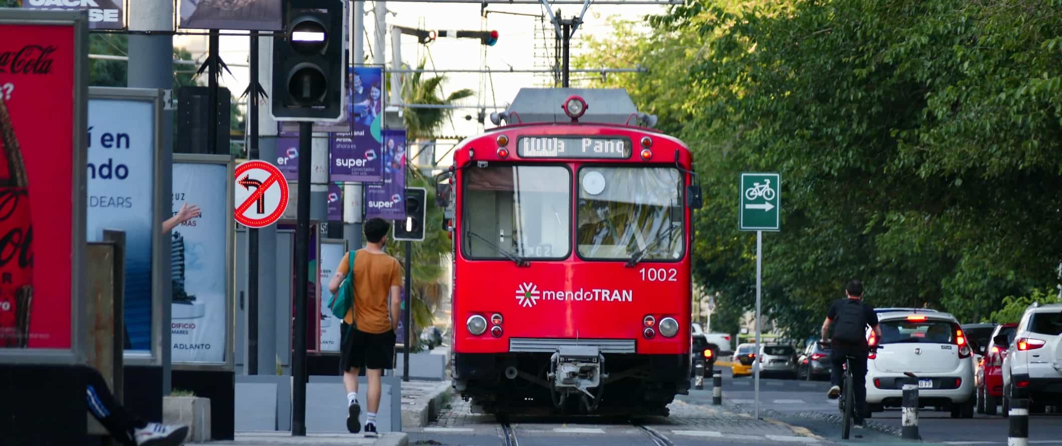 Red tram running along the street in Mendoza, Argentina