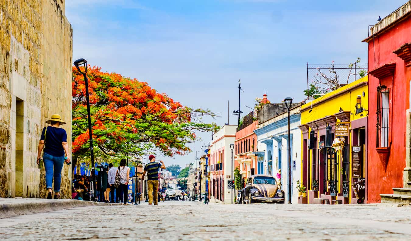 Colorful street with pedestrians on a sunny day in Oaxaca, Mexico