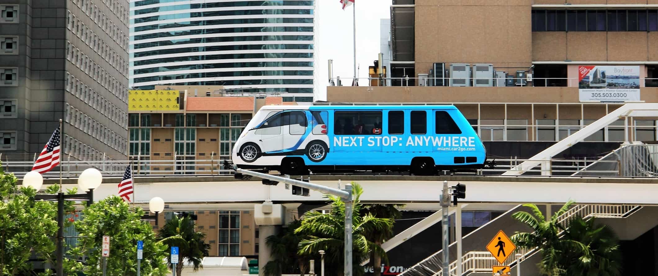 Blue metromover monorail surrounded by tall buildings in downtown Miami, Florida