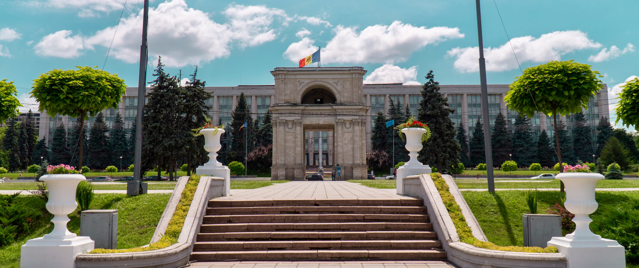 A historic building in the capital city of Chisinau on a bright summer day with the flag waving