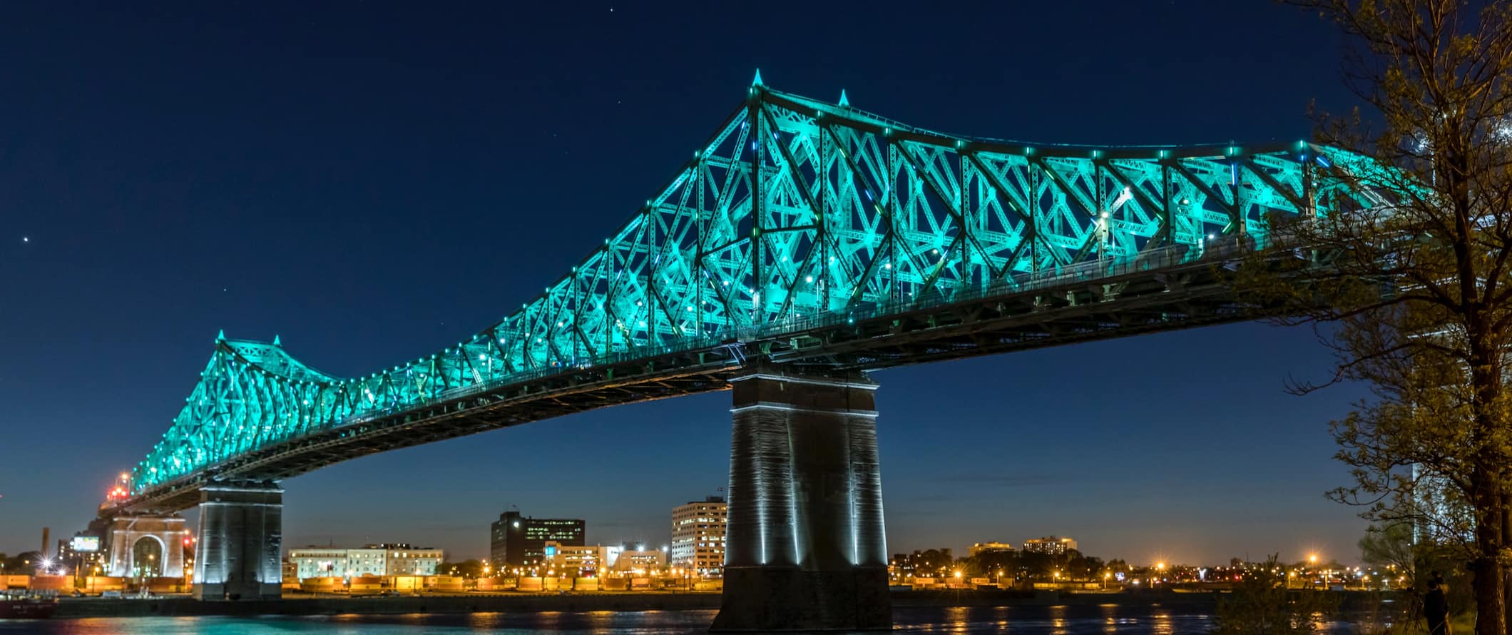 The iconic Cartier bridge in Montreal, Canada lit up at night