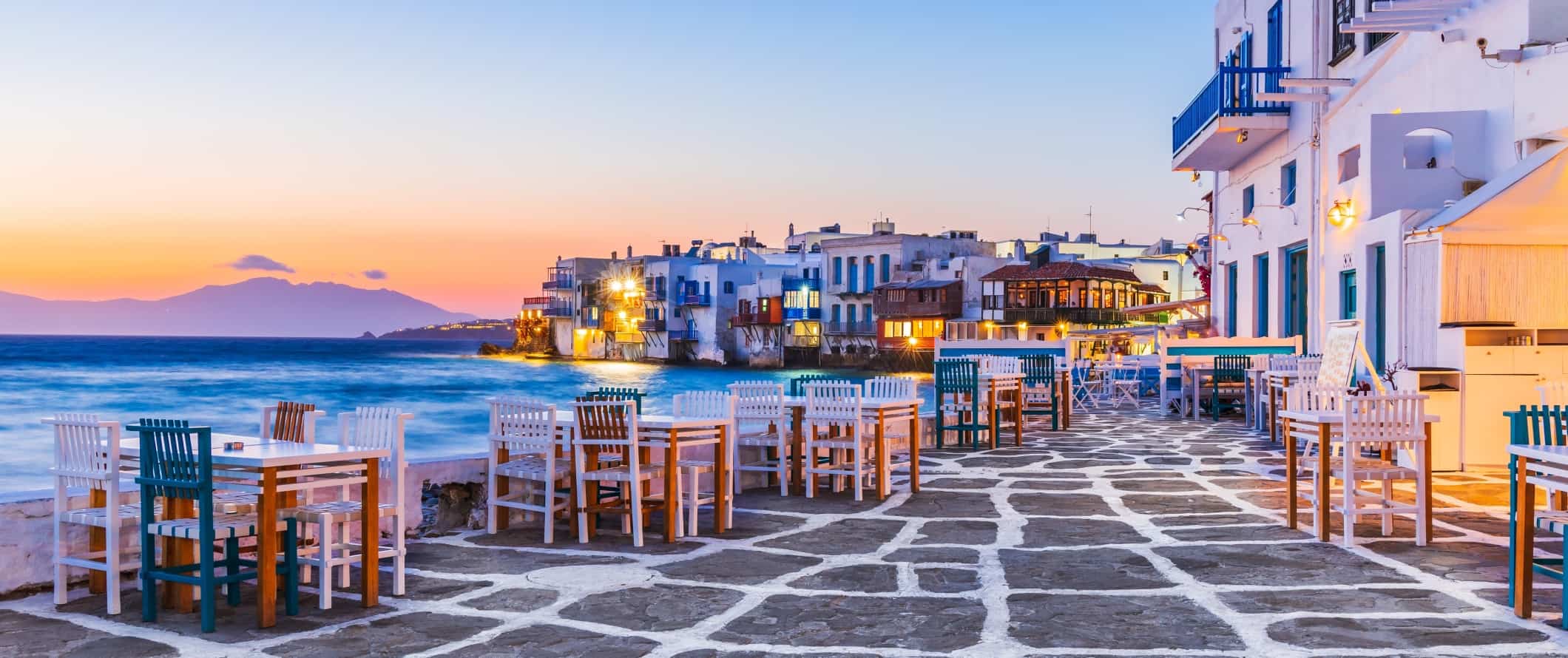 The harborfront and Old Venice neighborhood on the island of Mykonos in Greece.