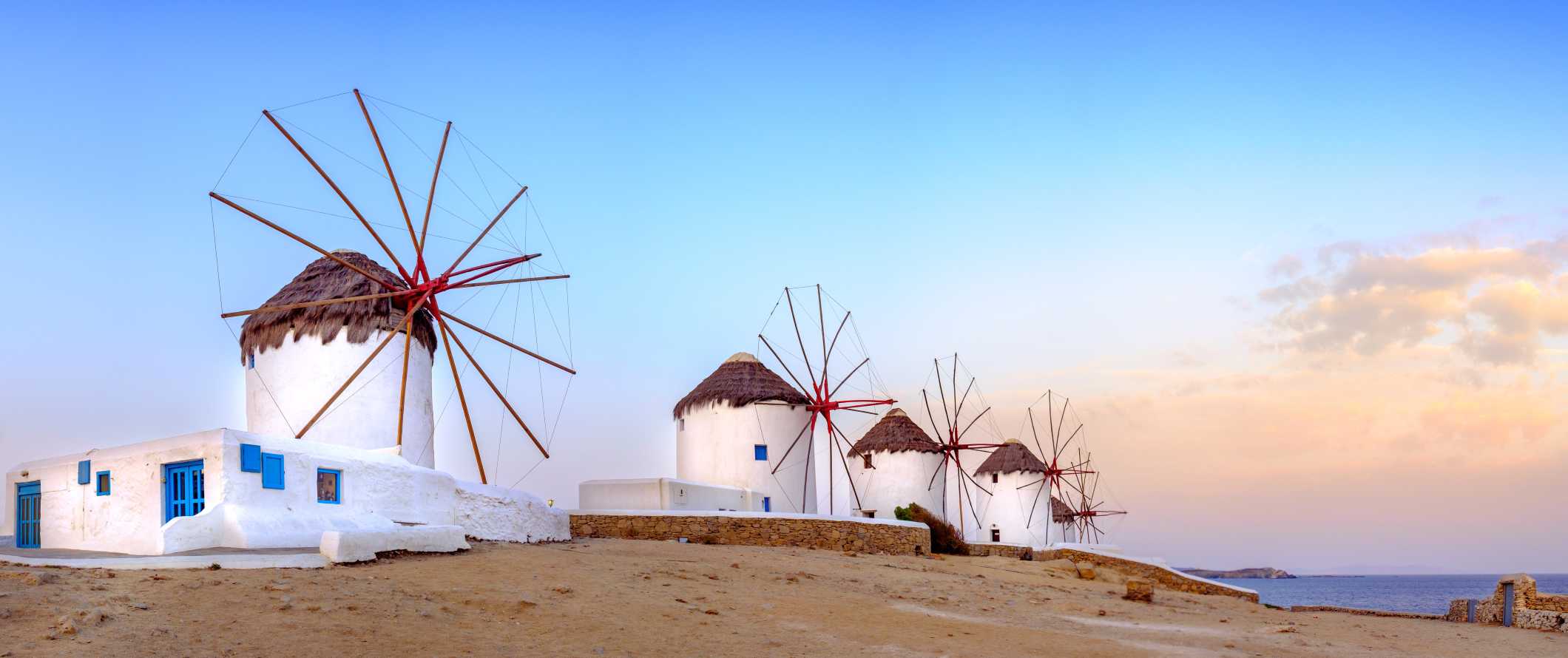 Four windmills at sunset on the island of Mykonos in Greece