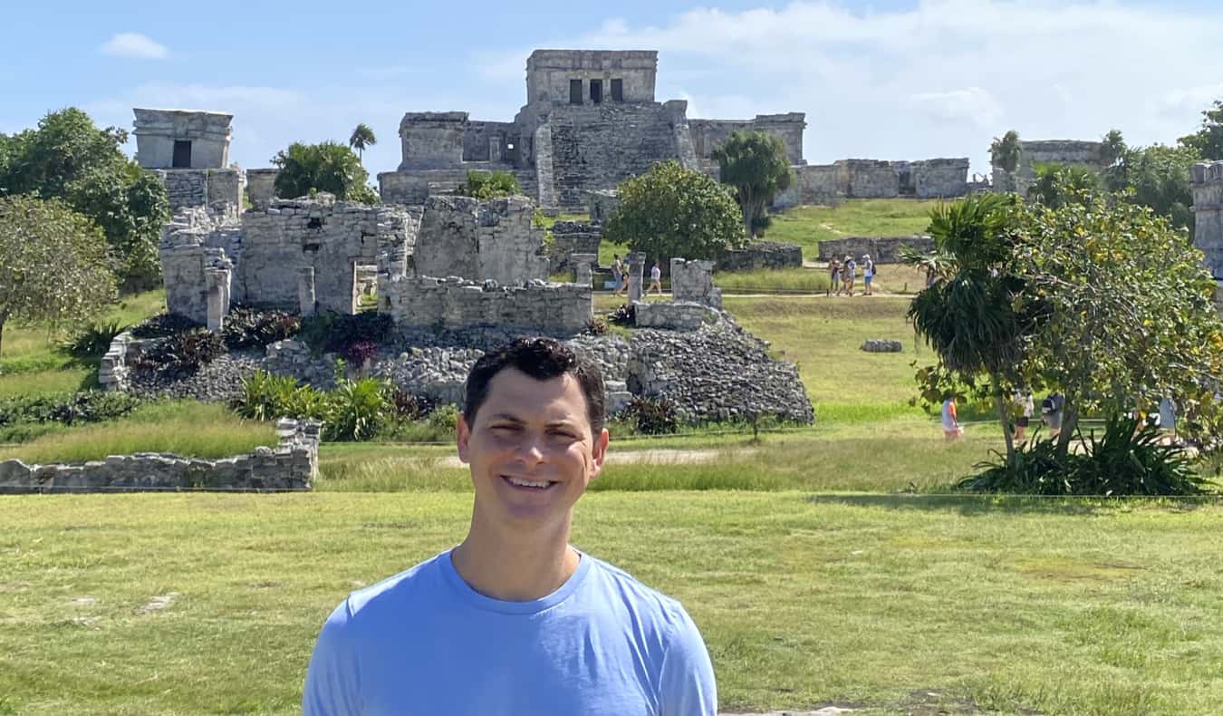 Nomadic Matt posing near the ruins in Tulum, Mexico