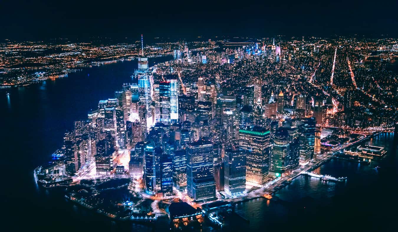 The iconic New York skyline lit up at night as seen from above